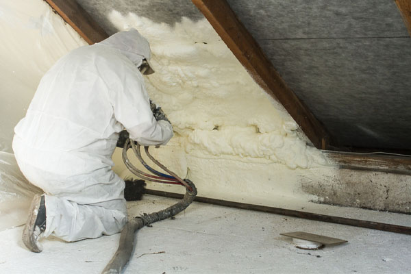 image of a spray foam insulation contractor installing spray foam in attic