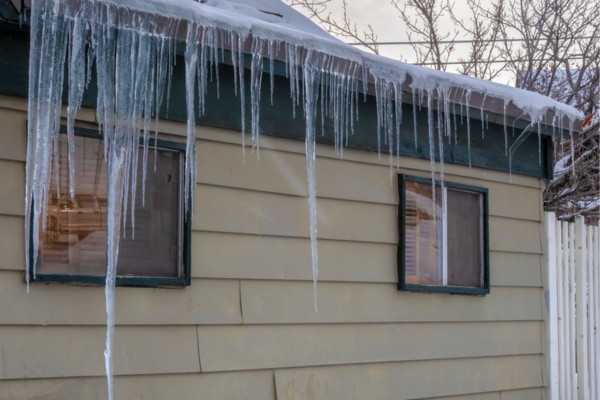 Ice dams on the gutter of a house