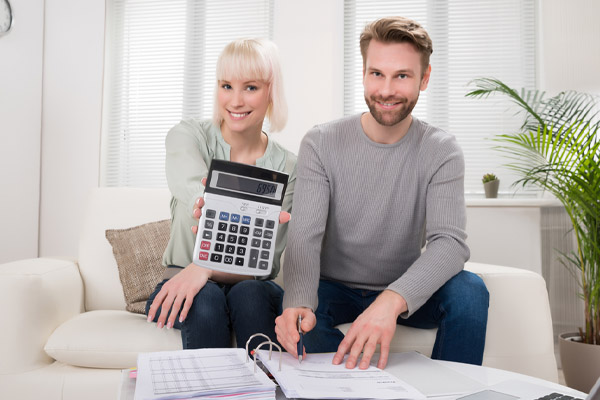 happy couple saving money with proper insulation