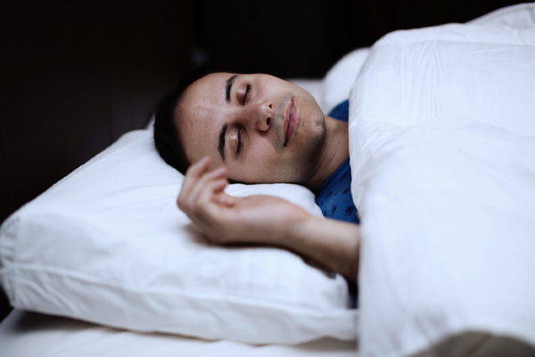 man sleeping soundly in bedroom with noise cancelling insulation