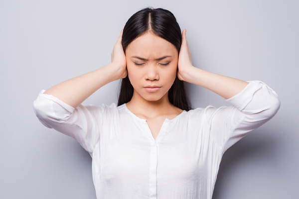 image of homeowner covering ears due to poor soundproofing