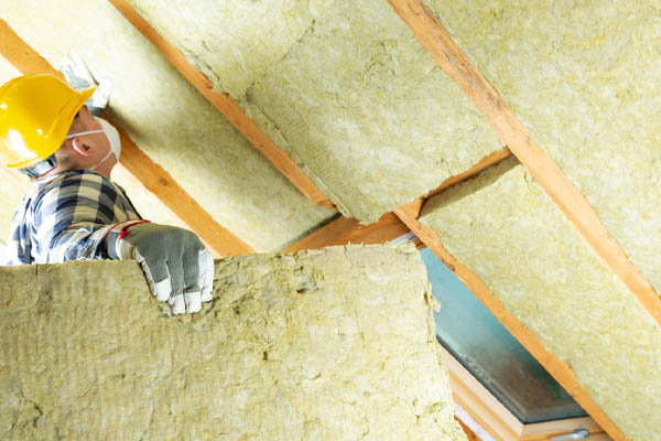 image of an insulation contractor installing rock wool insulation
