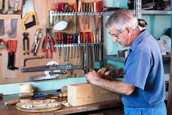 image of a homeowner comfortably working in the garage depicting garage insulation