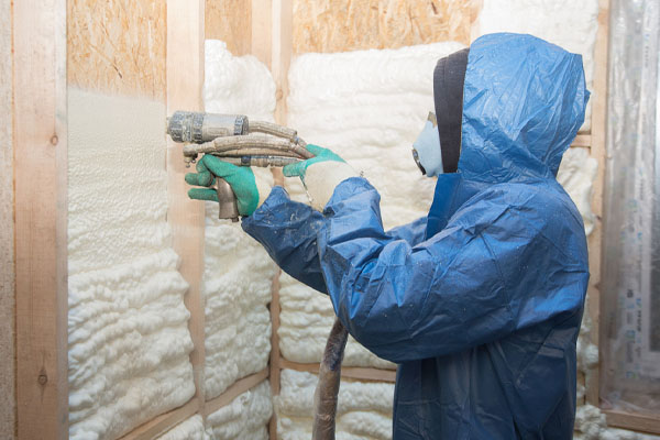 image of an insulation contractor applying foam to the walls of a fort collins house