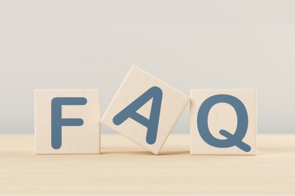 FAQ spelled using wooden letter cubes depicting questions about spray foam insulation & airtight house