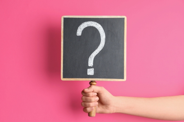 hand holding question mark sign depicting FAQs about Energy Bills & Efficient Home Tips