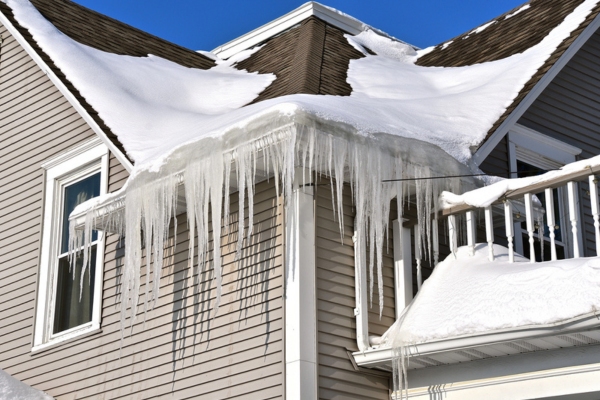 image of an ice dam depicting home without proper insulation image of an ice dam on gutter depicting home without proper insulation