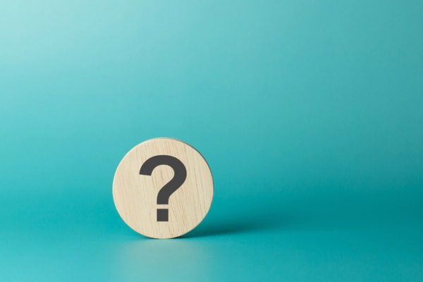 question mark on wooden circular chip depicting FAQs about Winter Home Insulation