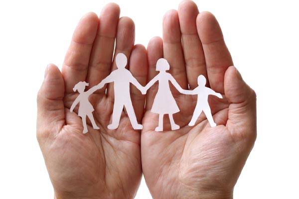 image of paper cut out of family in hands depicting fireplace safety