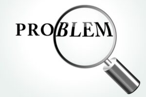 problem word highlighted by magnifying glass depicting fiberglass insulation