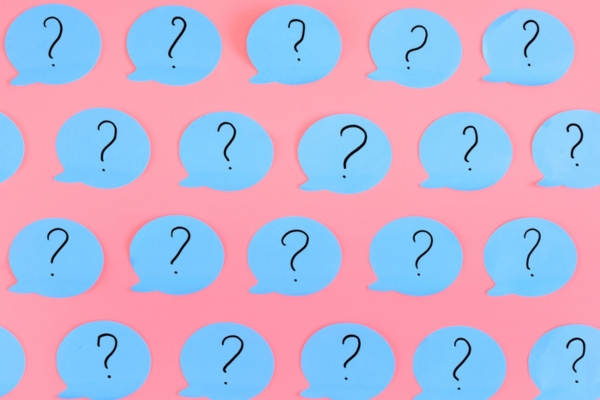 question marks on cutout speech bubble depicting FAQs about Attic Ventilation and Insulation