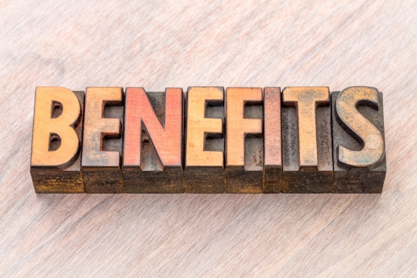 BENEFITS spelled using wooden letterpress depicting Spray Foam Insulation