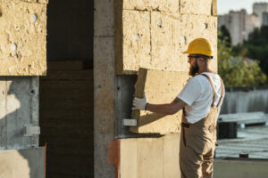 image of an insulation contractor installing thermal insulation