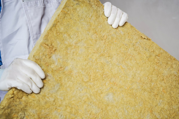 image of insulation contractor with mineral wool from attic
