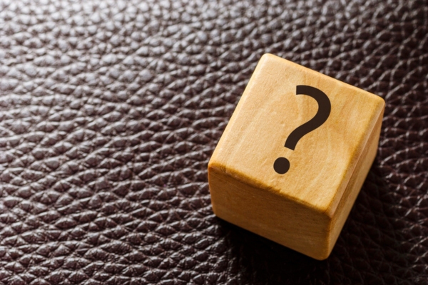 question mark on a wooden letter cube depicting Spray Foam Insulation FAQs