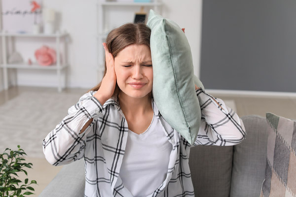 image of homeowner covering ears due to neighbors making noise and insulation