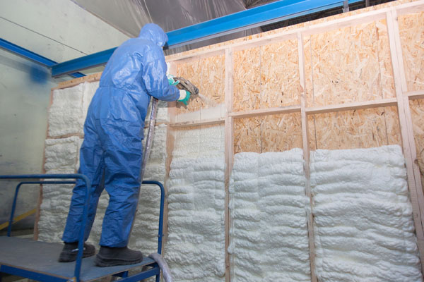 image of an insulation contractor installing spray foam