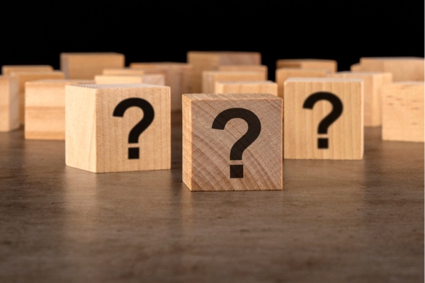 question marks on wooden cubes depicting Insulation Upgrade FAQs