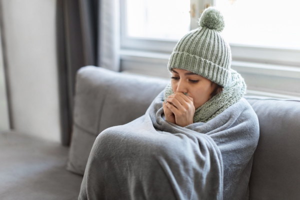 woman feeling cold indoors due to poor insulation