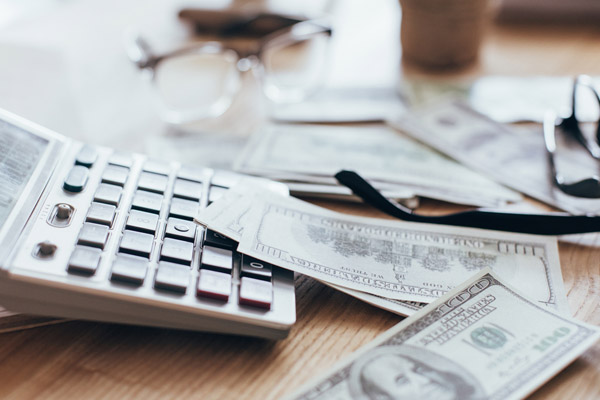 calculator and bank notes depicting insulation costs