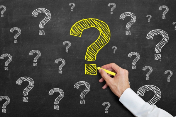 question mark drawings on a chalkboard depicting FAQs about benefits of insulation