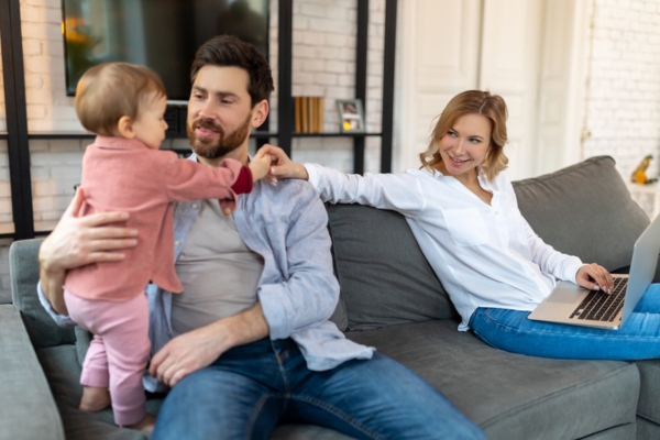 family happily lounging on the couch depicting cool indoor temperature