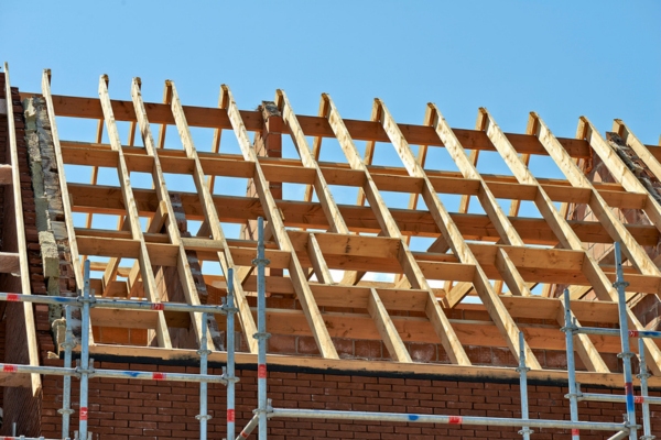 roof trusses depicting roofing insulation installation process
