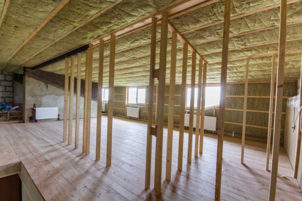 image of a home construction showing installation of insulation material
