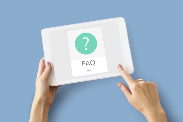 woman holding a smart tablet with FAQ displayed on the screen