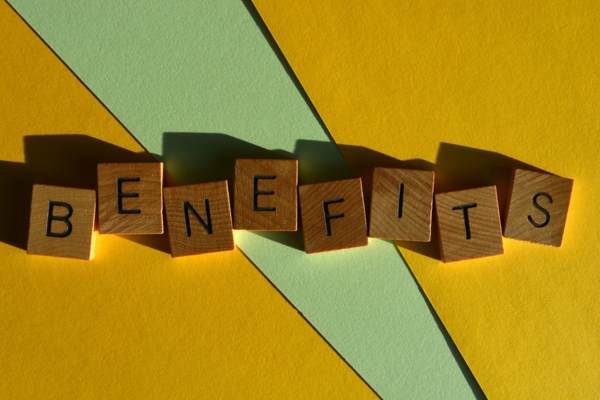 BENEFITS word spelled using wooden letter chips