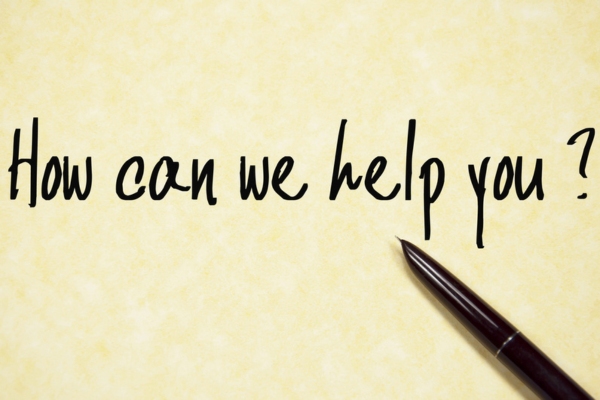 HOW CAN WE HELP YOU text written on a yellow paper