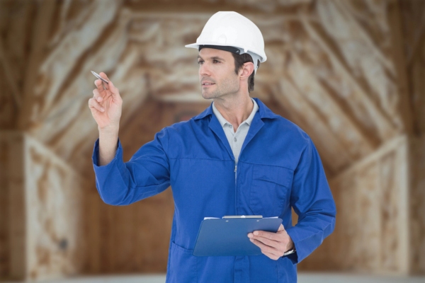 insulation inspector holding a clipboard and pen while examining a house
