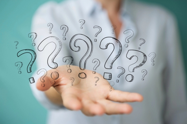 woman presenting doodled question marks depicting Insulation Damage FAQs