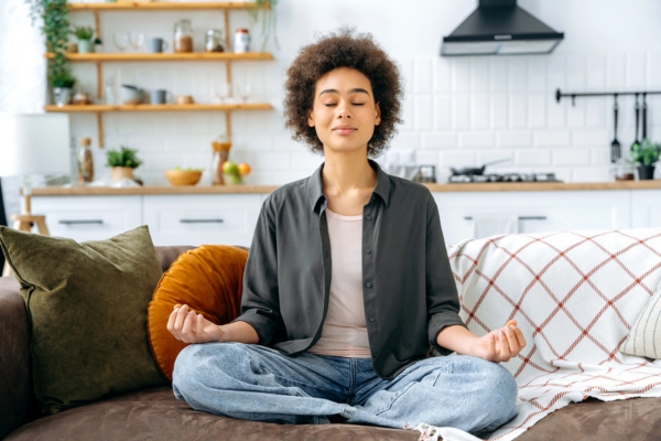 homeowner breathing and meditating at home depicting good indoor air quality