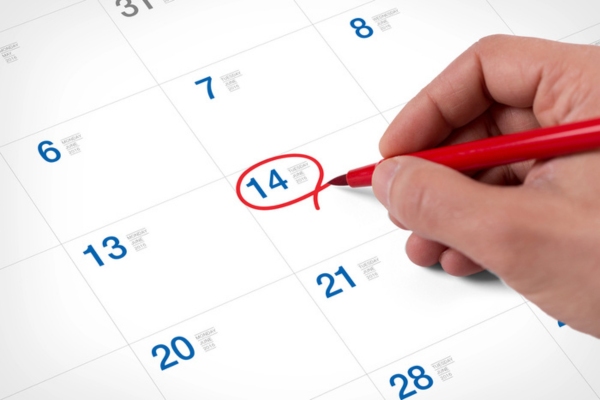 homeowner encircling a date on a calendar for an energy audit schedule