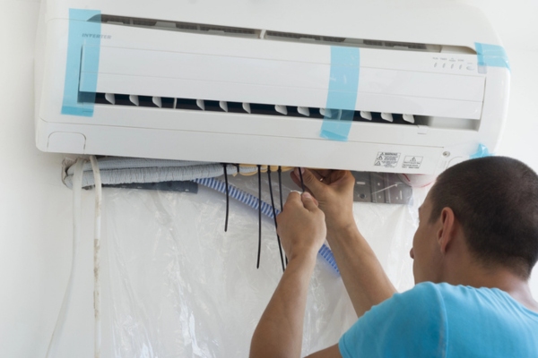 HVAC technician installing a new ductless air conditioner