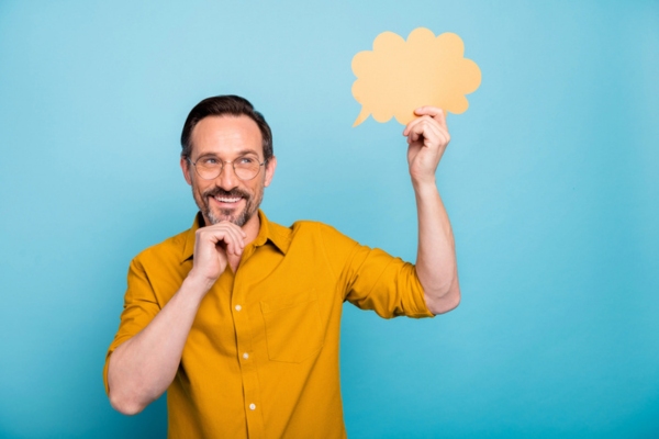 image of a man thinking while holding speech bubble depicting How Audit Results Support Smarter Improvements