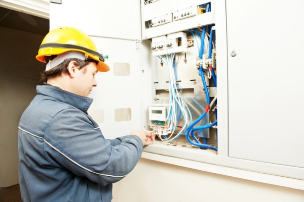 male electrician working on an electrical box