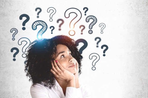 woman looking up at question mark doodles around her head depicting Attic Insulation for Summer FAQs