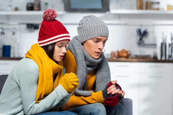 couple in warm clothing due to furnace breakdown